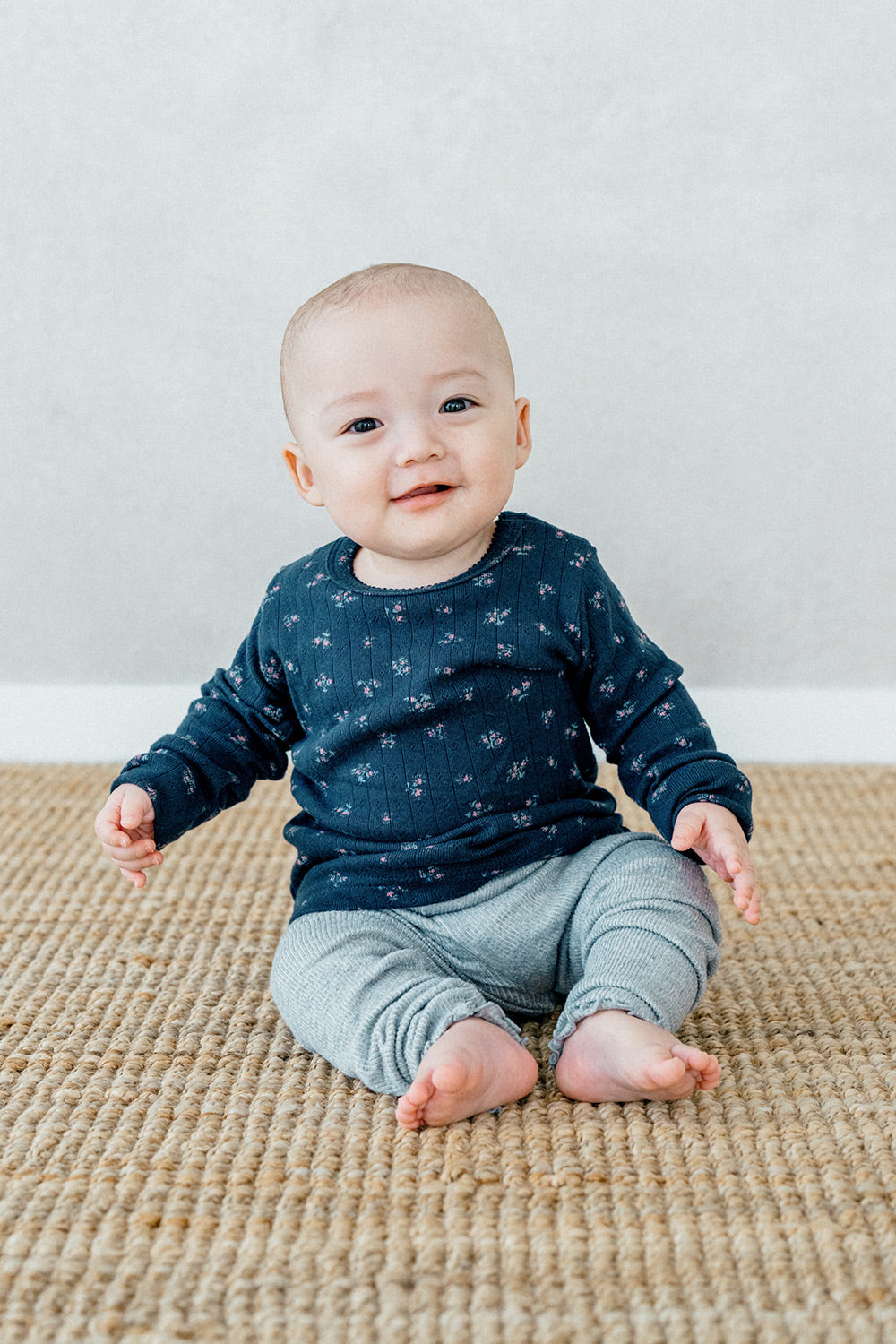 Close-up of a baby in Avauma Picot Flower Setup - Lunabel Gray, showing the soft and comfortable floral-patterned sleepwear with a matching gray headband.