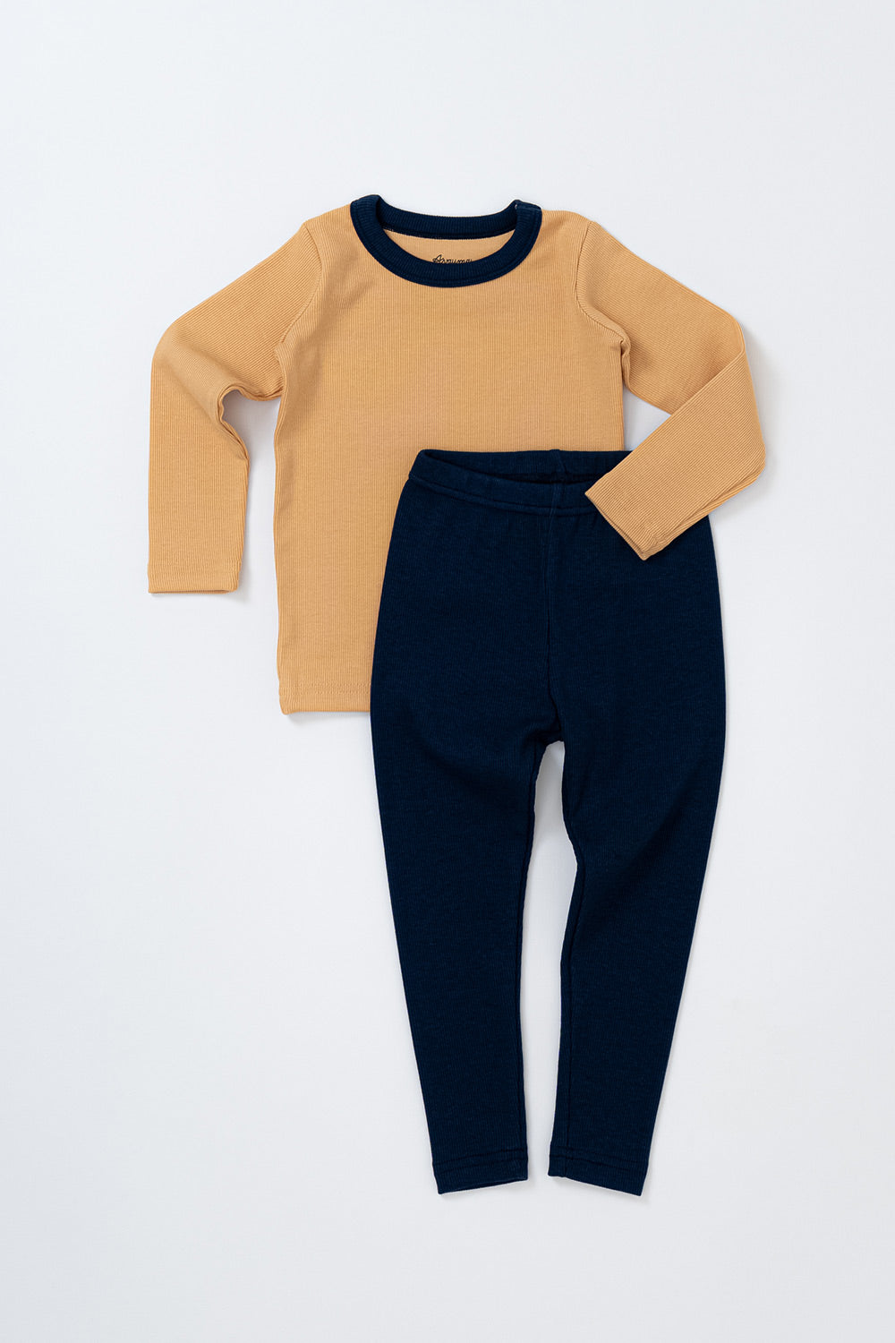 
Flat lay of Avauma's Coco Classic Long Sleeve Set in Mango Marine color - featuring a yellow top with navy pants, designed for cozy baby sleepwear and pajamas.