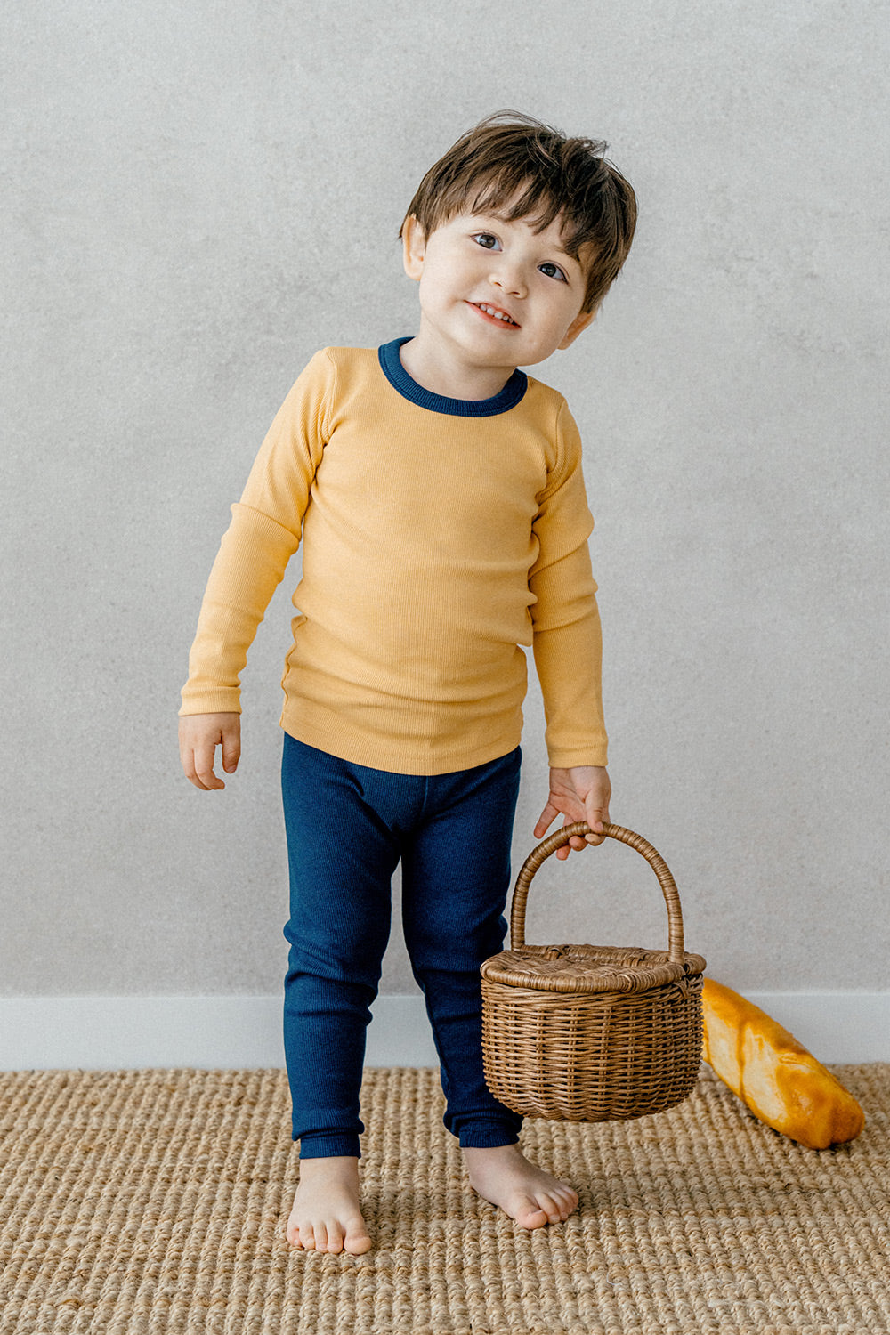 Toddler smiling while wearing Avauma's Coco Classic Long Sleeve Set in Mango Marine color - stylish and comfortable baby loungewear ideal for all-day wear.