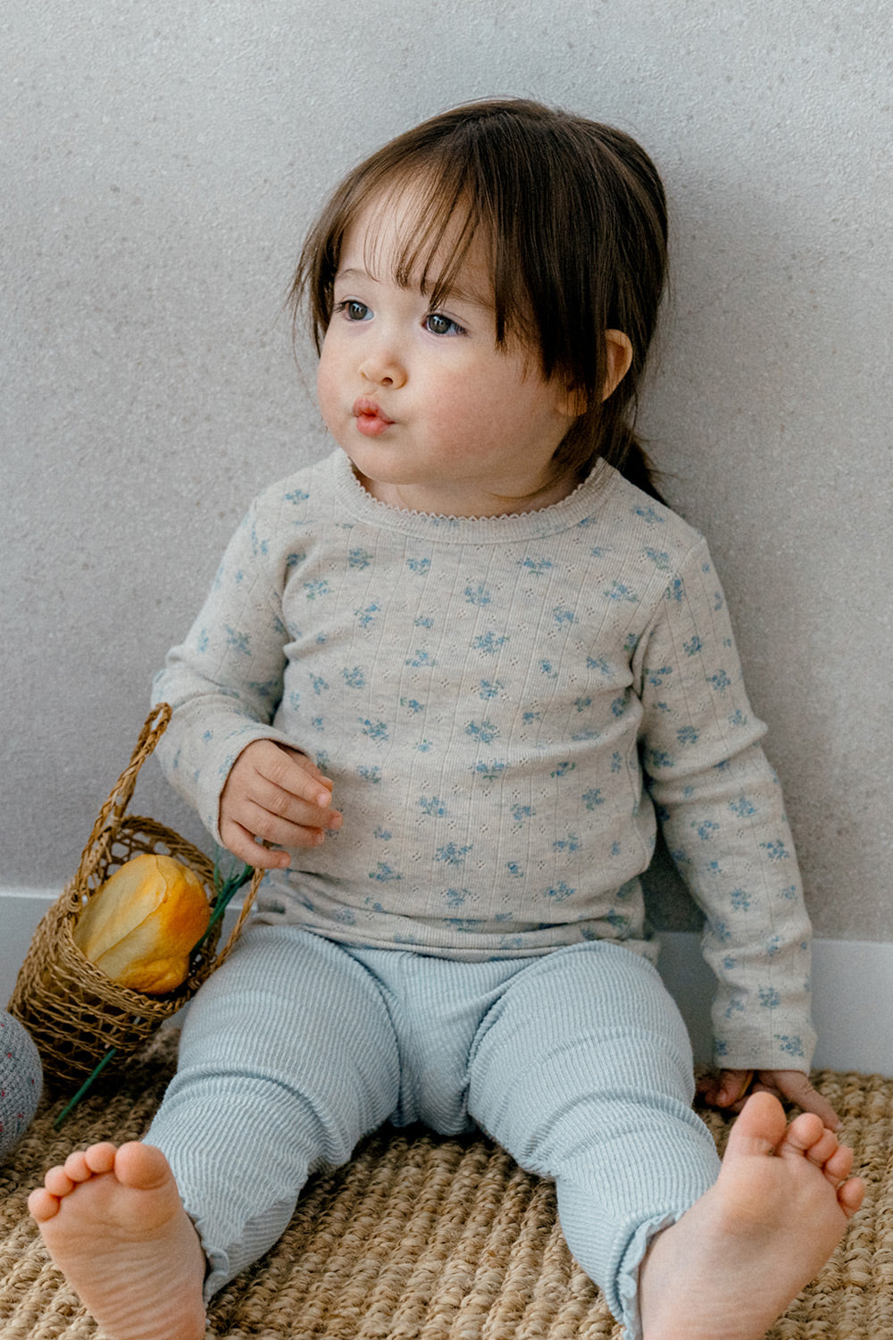 Toddler sitting in Picot Flower Setup - Pebble Green by Avauma, a charming floral print baby sleepwear set for comfortable day and night wear.