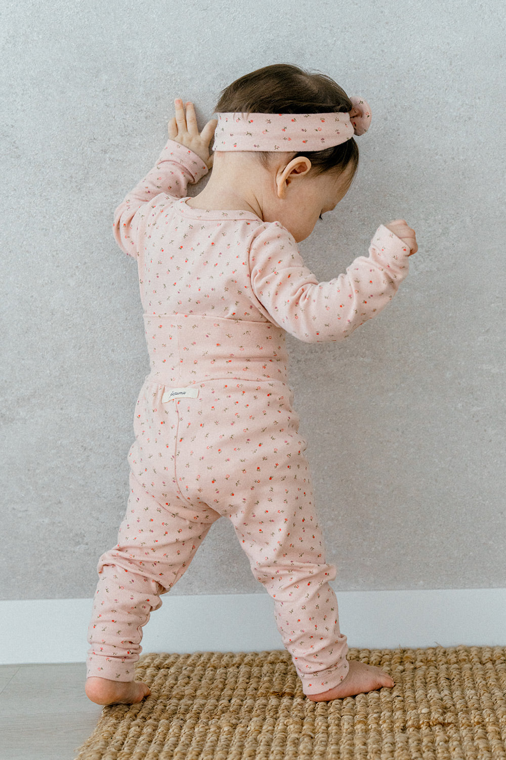 Flat lay of Avauma Floral Melody Long Sleeve Baby Pajamas - Powder Pink, showcasing the delicate floral patterns on soft baby pajamas.