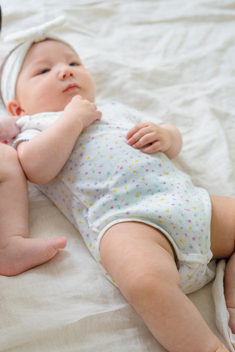 Baby Lying on Back in Avauma Soft Rose Butter Garden Short Sleeve Bodysuit, Comfortable and Cute Outfit

