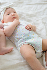 Baby Lying on Back in Avauma Soft Rose Butter Garden Short Sleeve Bodysuit, Comfortable and Cute Outfit

